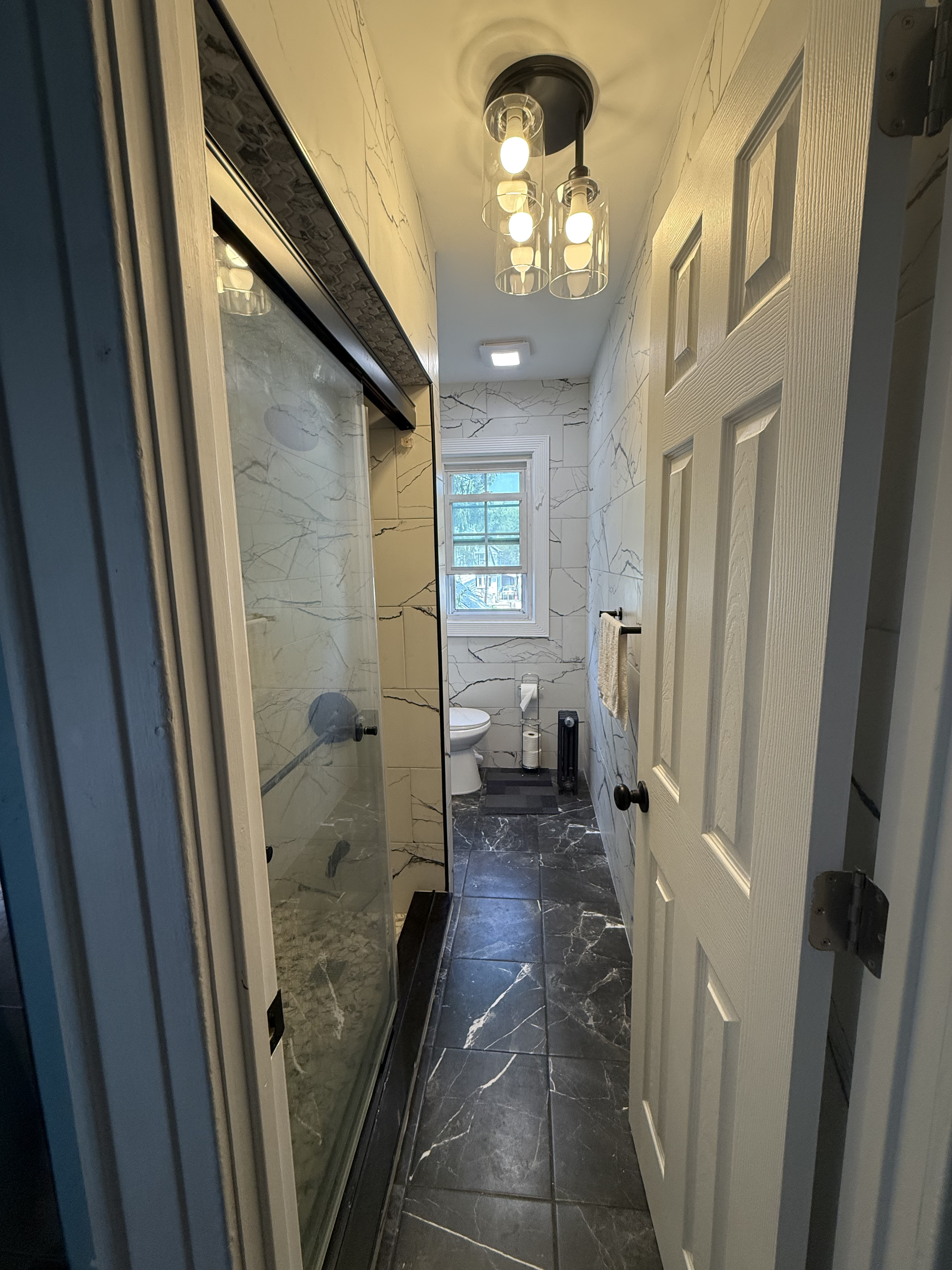 Bathroom renovation with dark marble tile